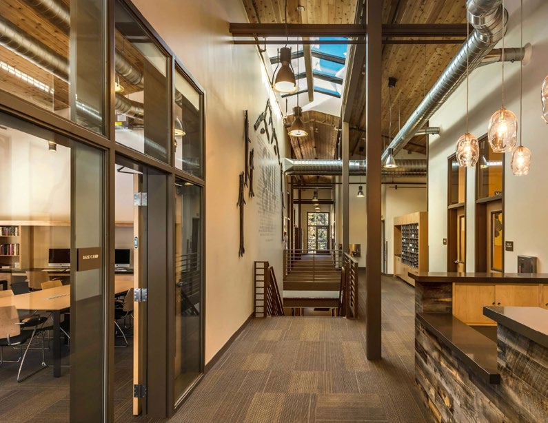 The Base Camp commons at Sugar Bowl Academy: timber beams, skylights, and study spaces.