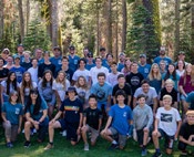 The full Sugar Bowl Academy staff and student community gathered for a group photo among the pines.