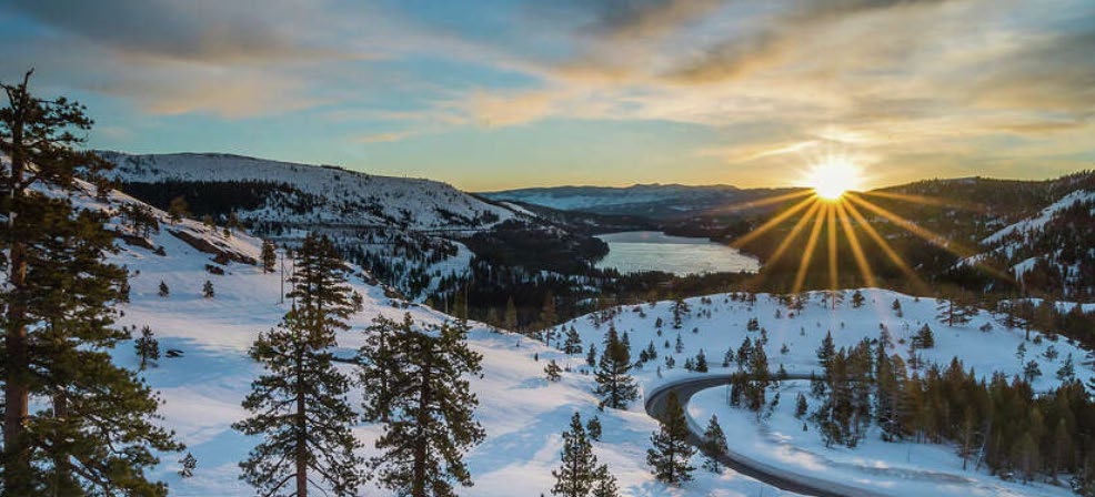 Sunset over Donner Lake and the snow-covered Sierra ridgelines above Donner Summit.