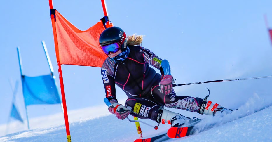 A Sugar Bowl Academy alpine racer carving past a gate in a giant slalom course.